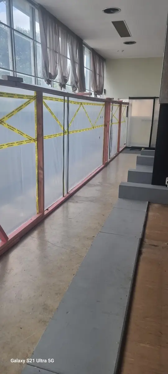 Enclosure wall running the length of the office corridor