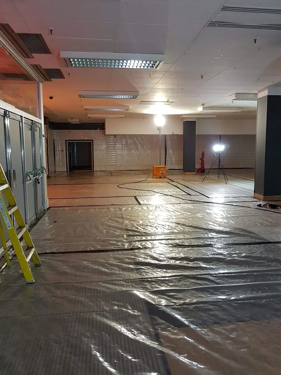 Office floor sheeted in black poly inside the asbestos enclosure