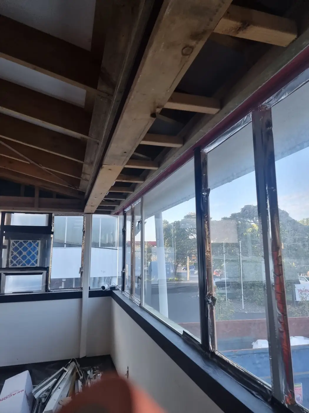 Ceiling framing and window exposed during a commercial office soft-strip