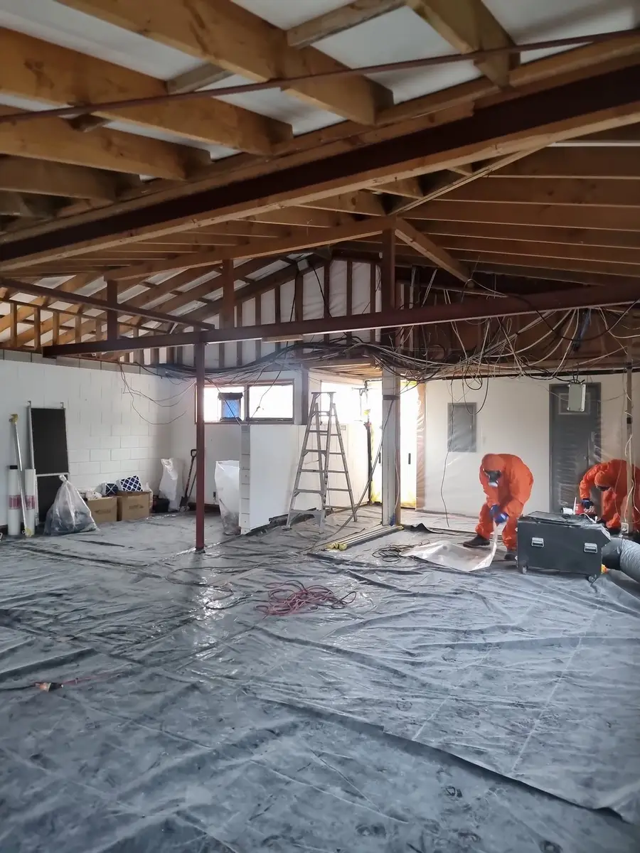 Office soft-stripped to the shell with ladders and poly sheeting