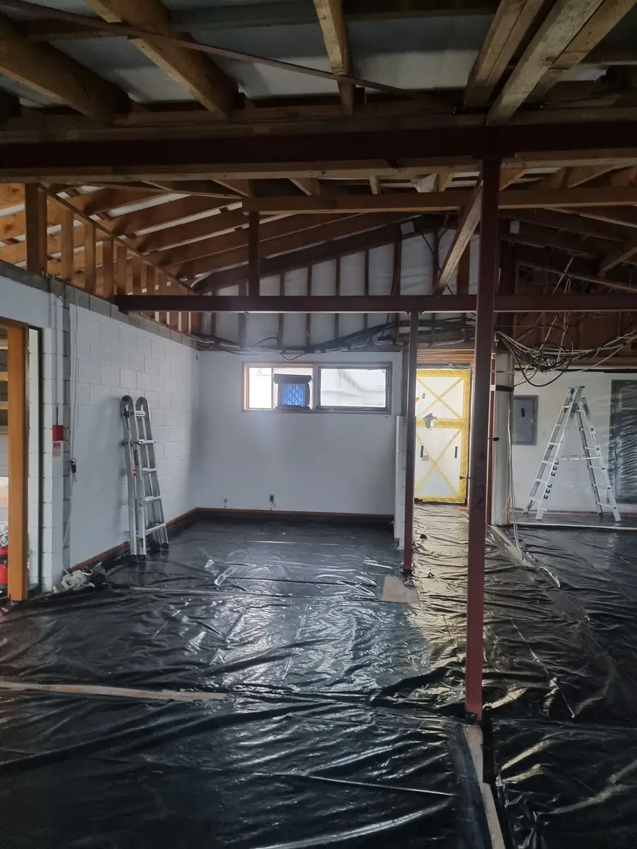 Office framing and windows with poly floor during the soft-strip