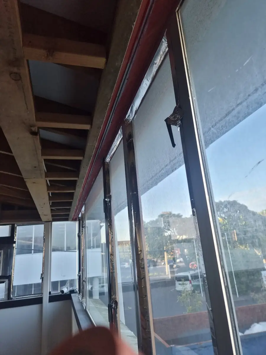 Window framing and steel beam exposed after ceiling linings were stripped