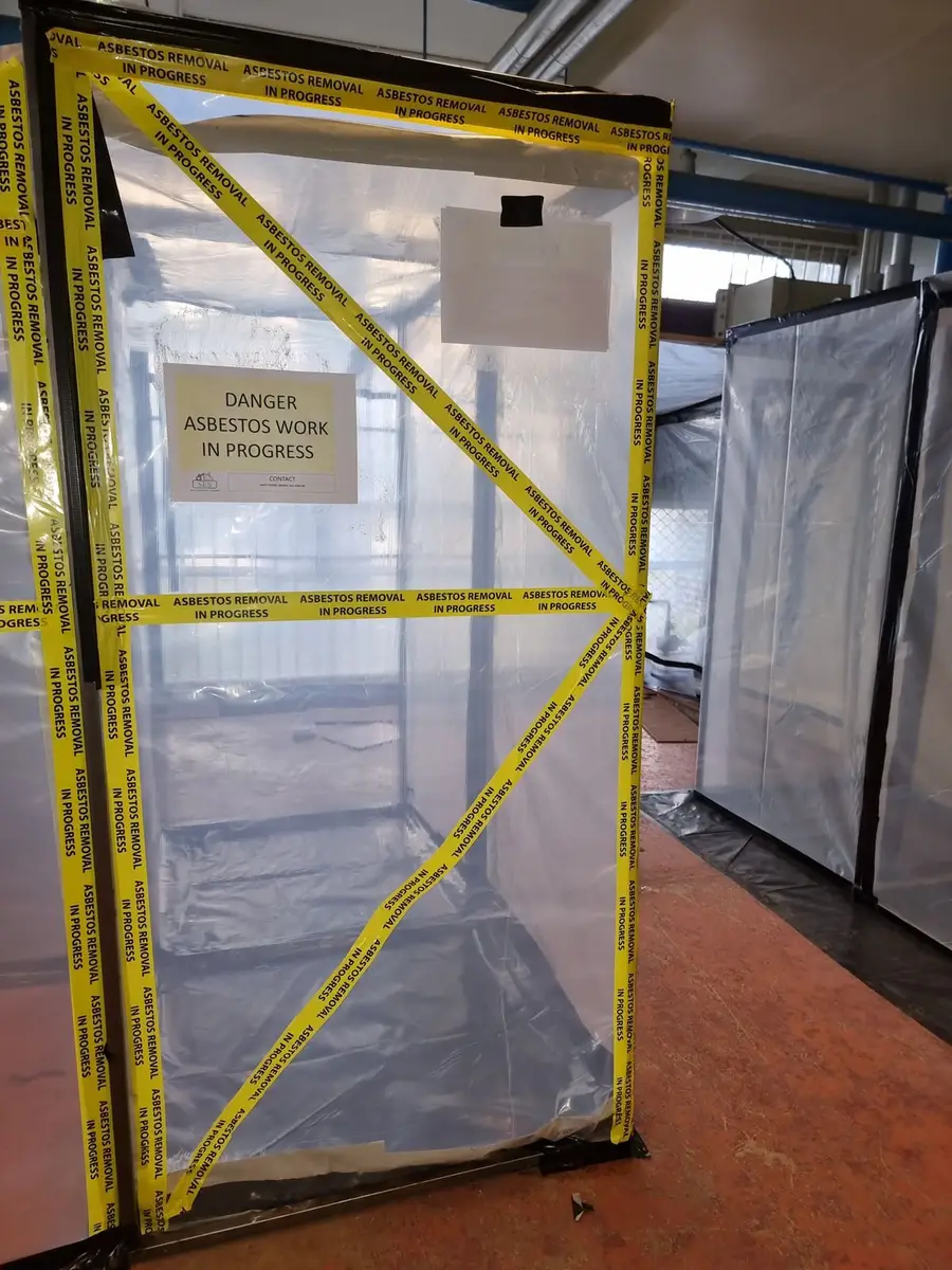 Airlock on the plant room asbestos enclosure marked with yellow tape