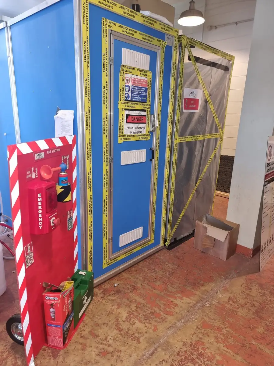 Blue decontamination unit door with signage in the plant room