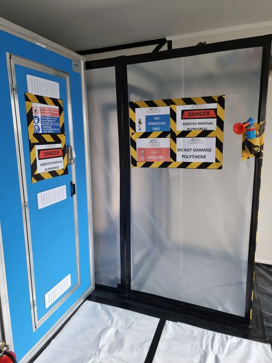 Decontamination unit with signage at a residential asbestos removal