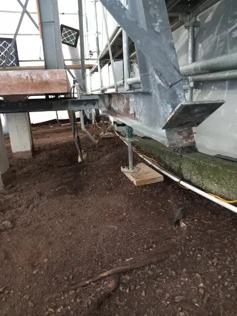 Inside the scaffold enclosure with the steel frame exposed during asbestos removal