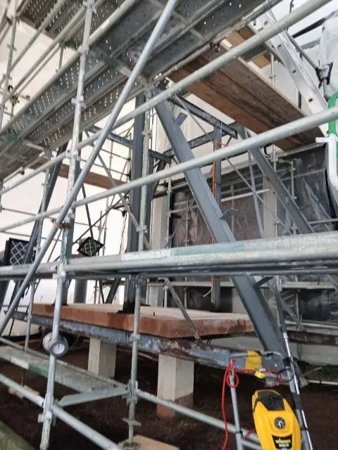 Scaffold enclosure, steel frame and tools during dismantling of the asbestos-cement hood