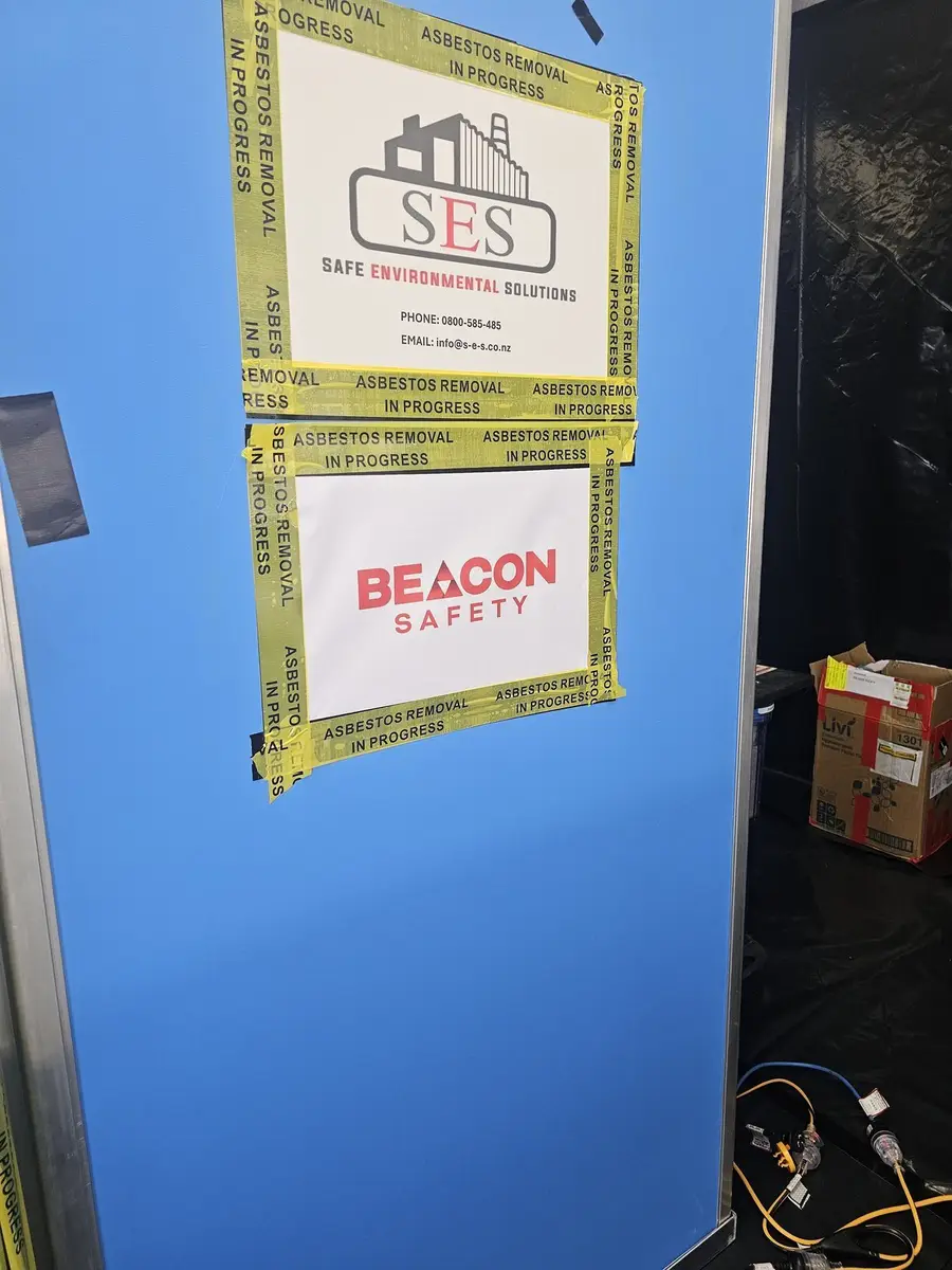 SES asbestos removal signage on the blue decontamination unit door