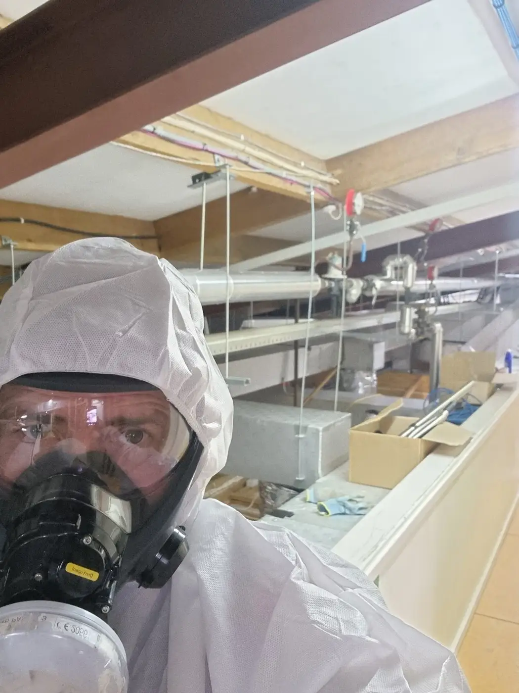 SES operative in a full-face respirator in the ceiling space