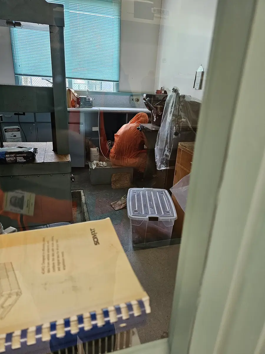 SES operative in orange coveralls at the office window
