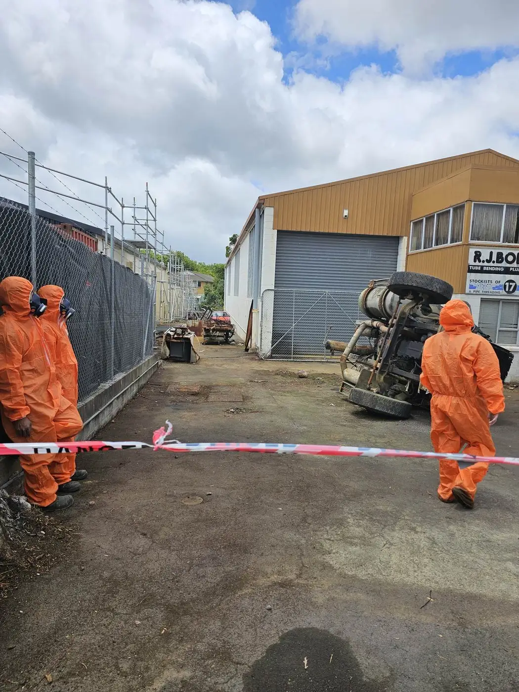 SES operatives in PPE during the crane lift in the industrial yard