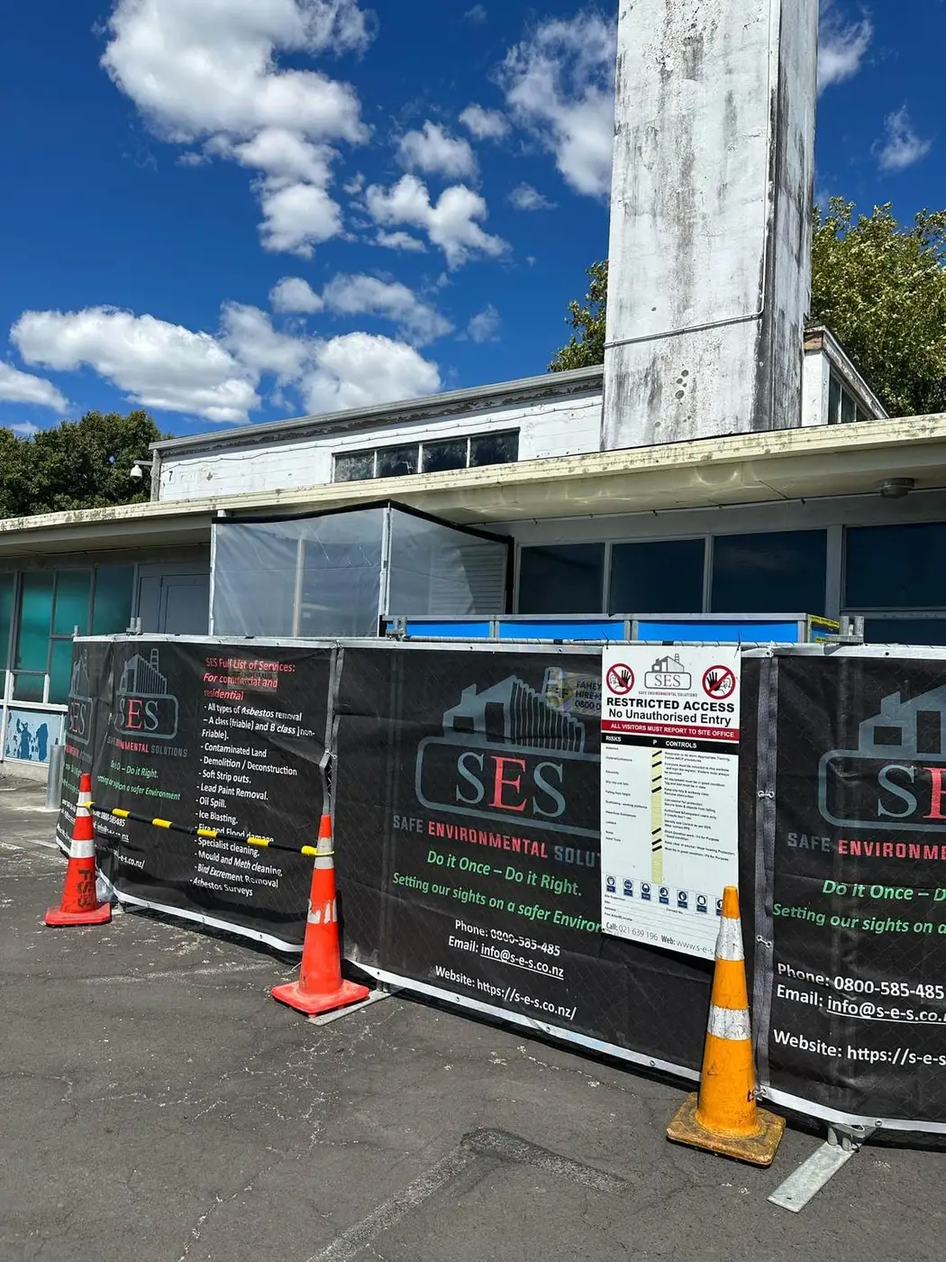 SES site hoarding and cones at a commercial building in Auckland