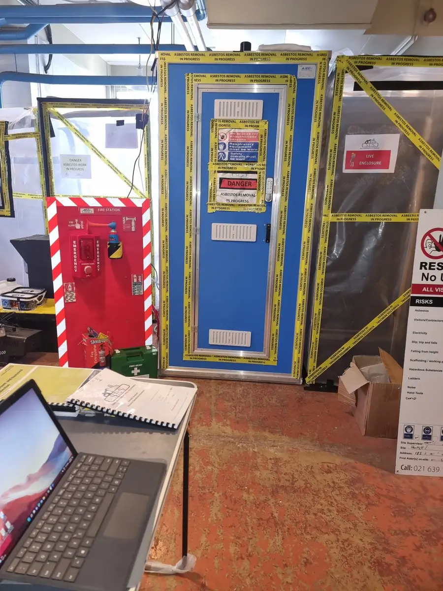 Site laptop and decontamination unit at the plant room asbestos job