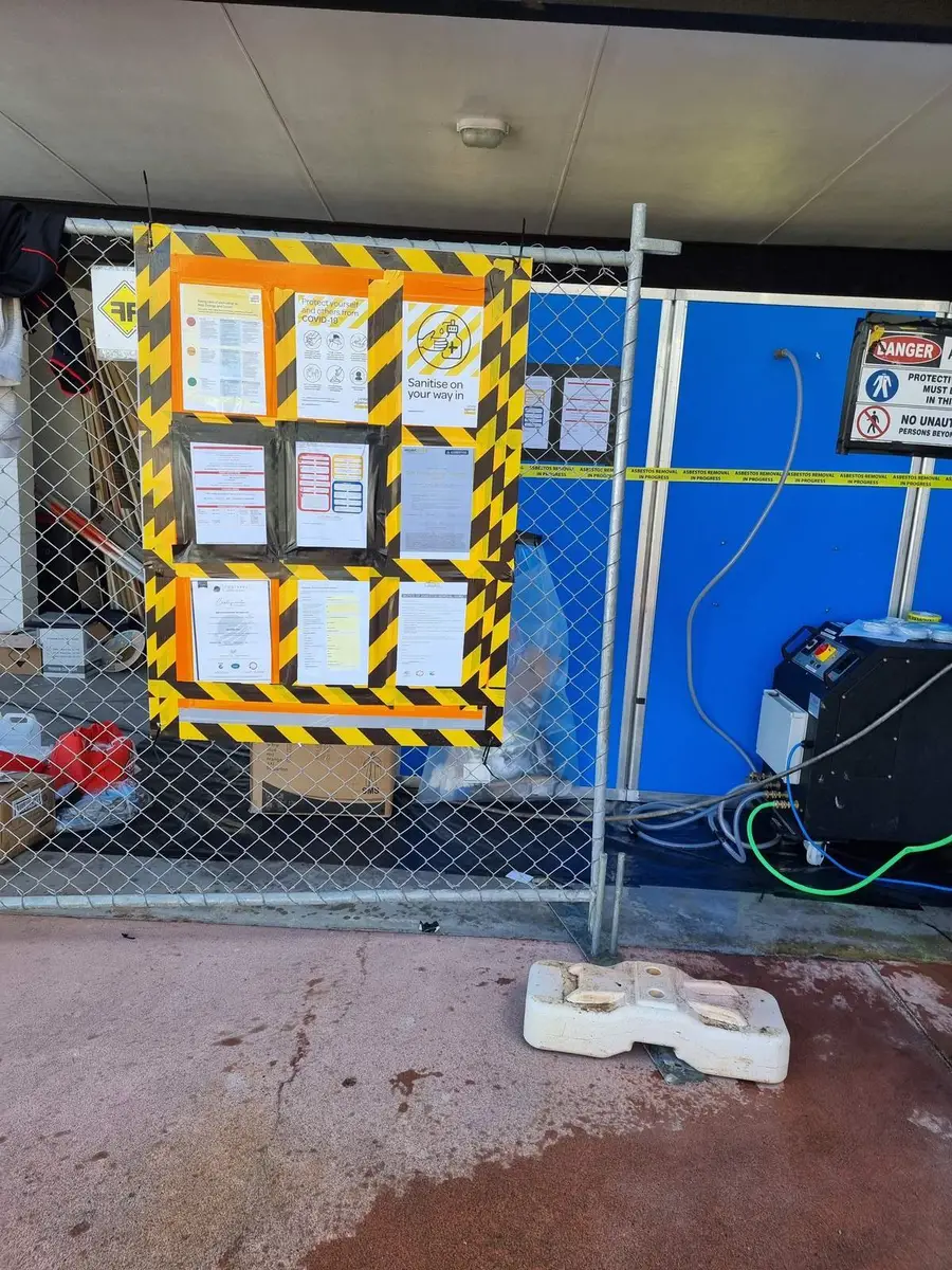 Site notice board on the fence at a commercial asbestos removal