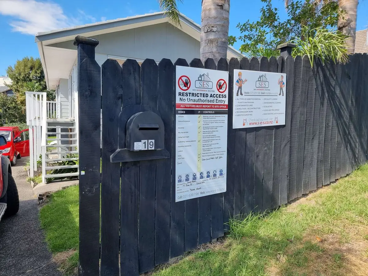 Site signage on the fence at the residential asbestos removal