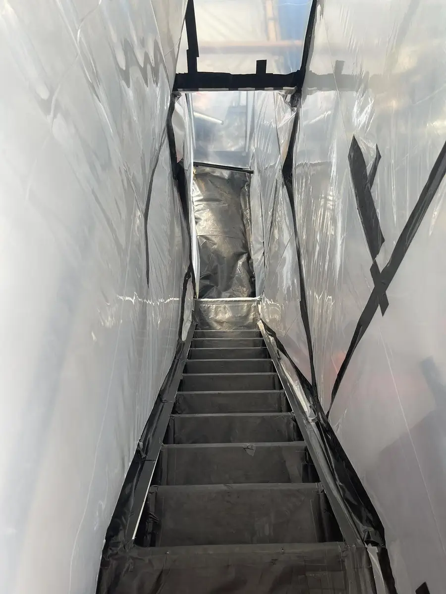 Stairwell sheeted in poly as part of the asbestos enclosure