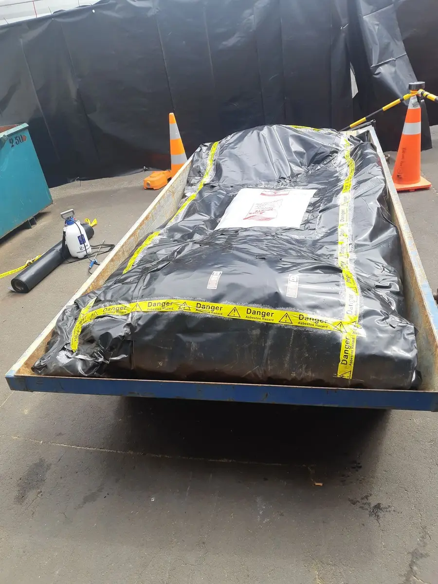 Wrapped and labelled asbestos waste on the trailer